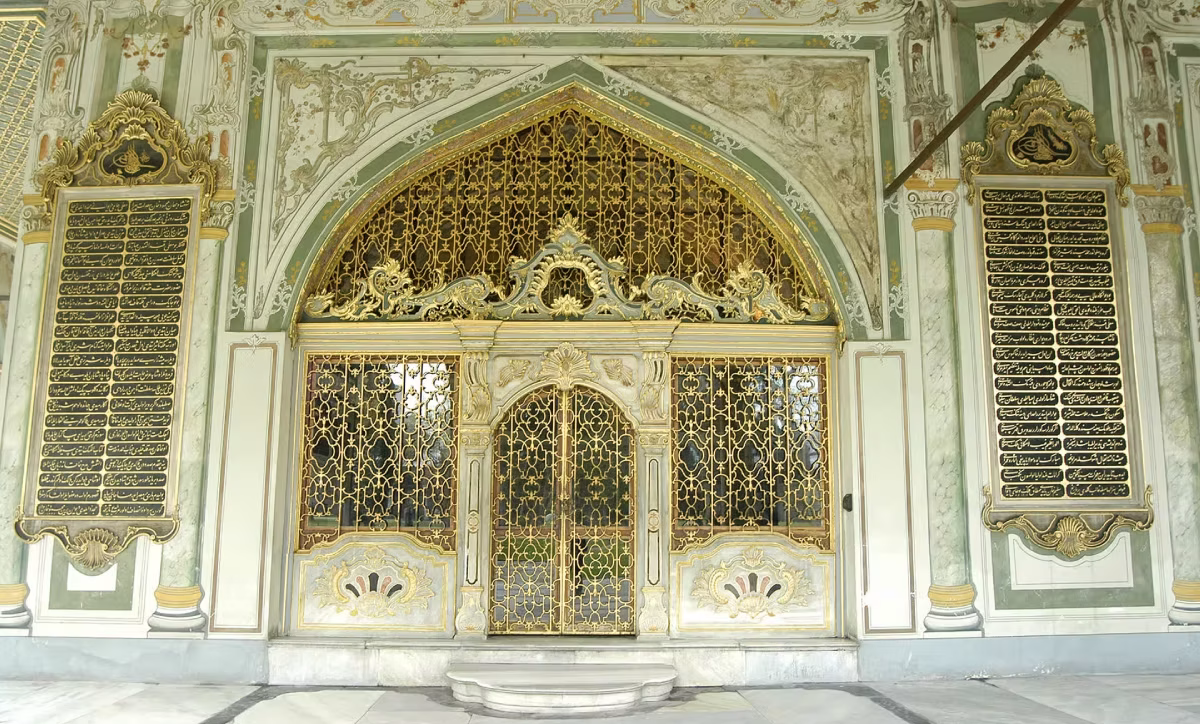 Ornate golden gate with Islamic calligraphy at the Sacred Relics Chamber in Topkapi Palace Istanbul.